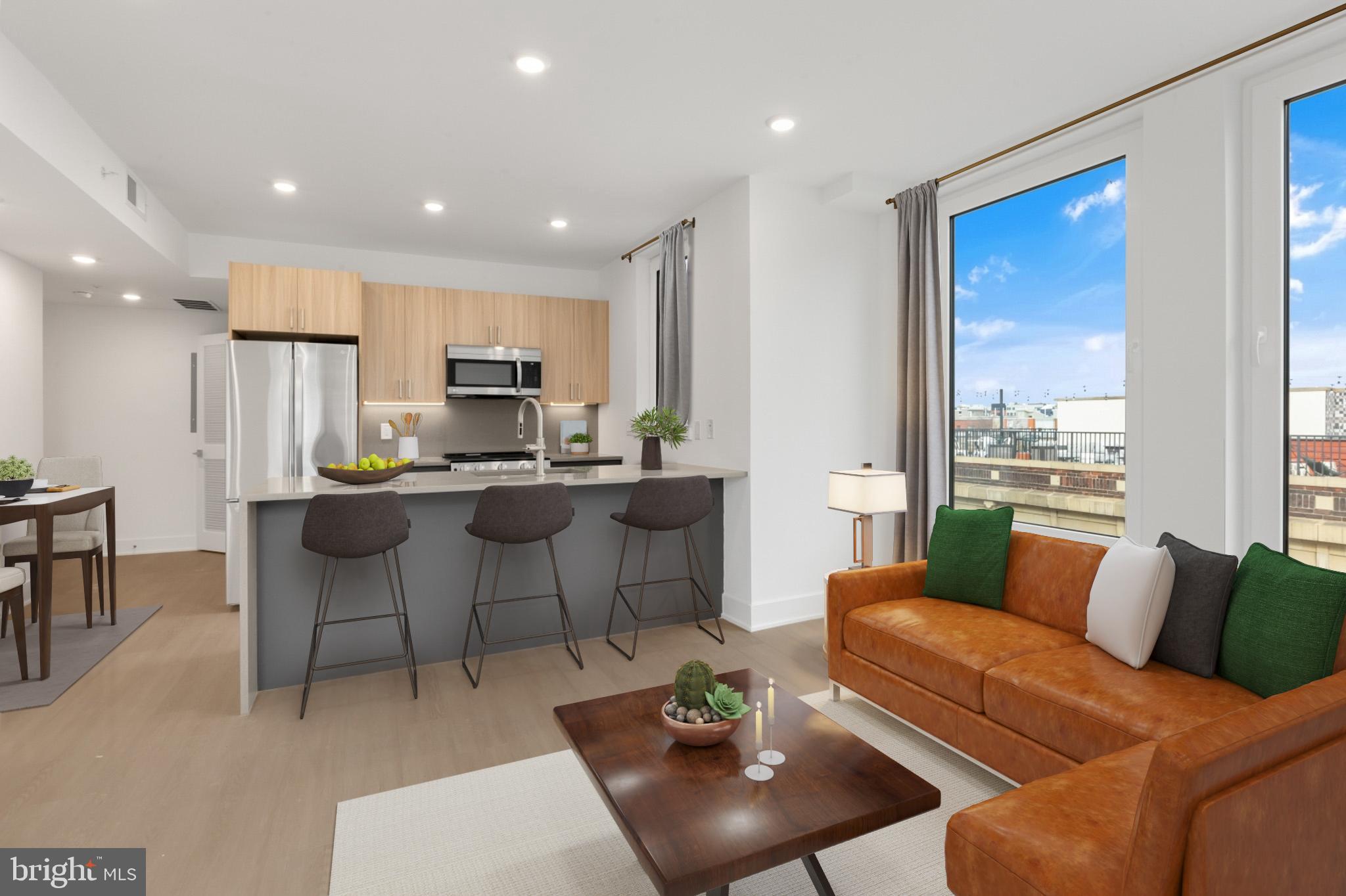 a living room with furniture kitchen and a table