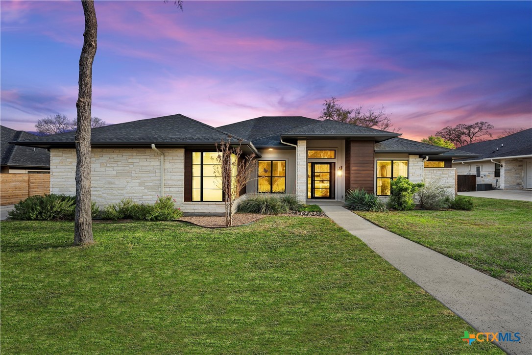 a front view of a house with a yard