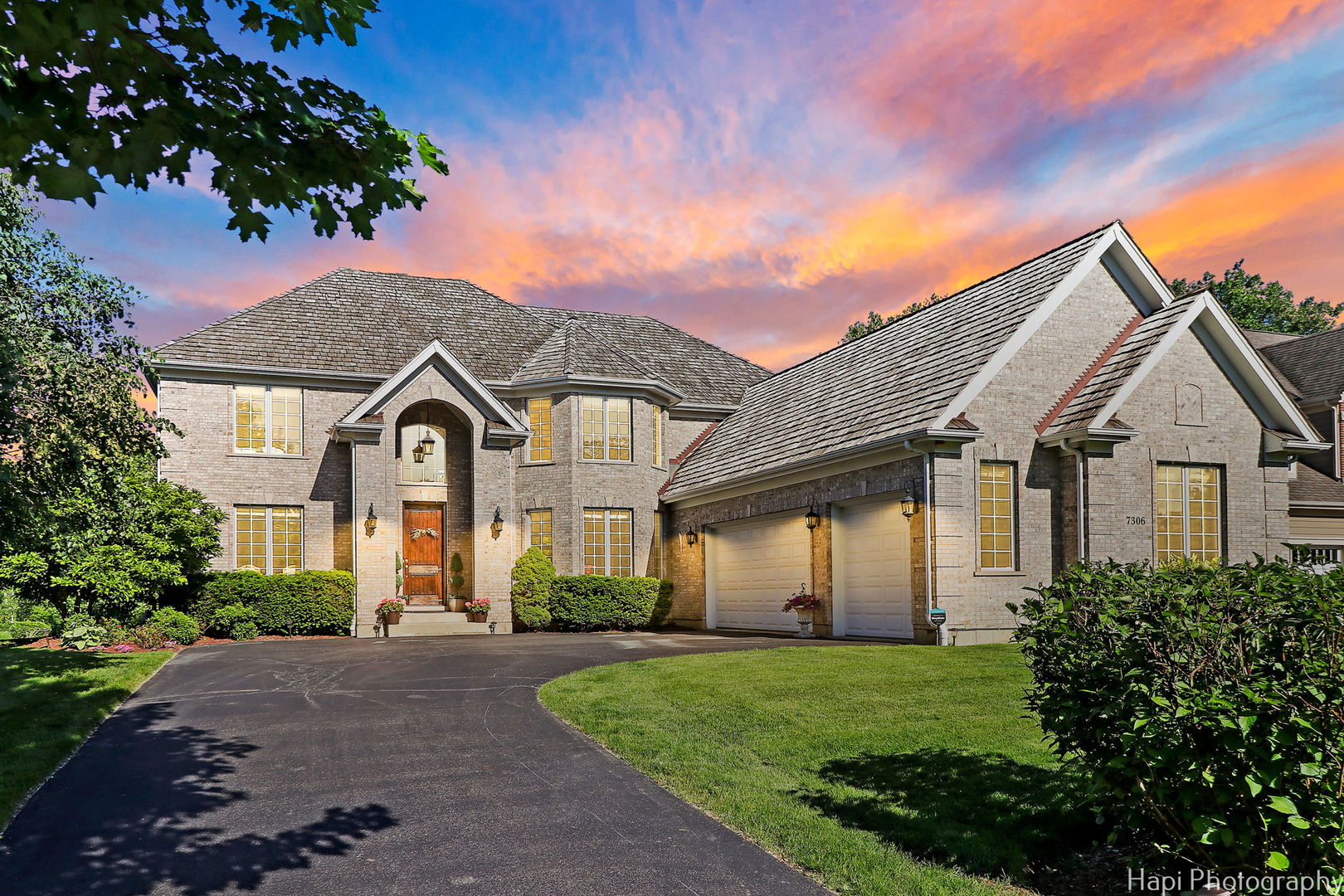 a front view of a house with a yard and garage