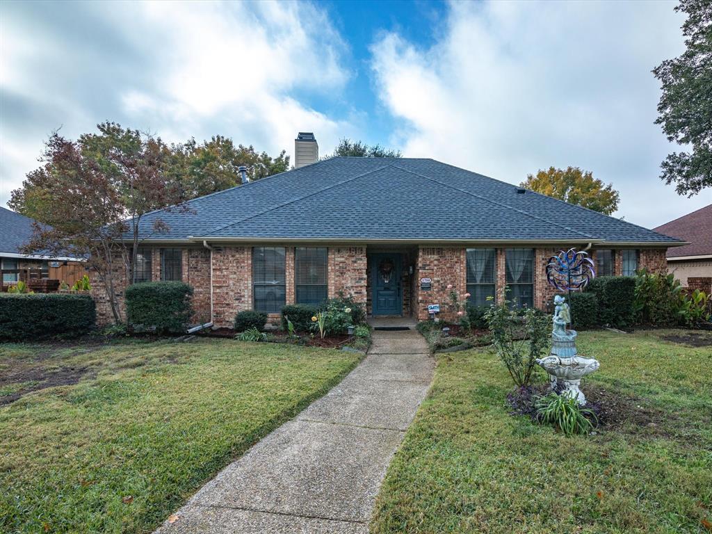 a front view of a house with a yard and porch