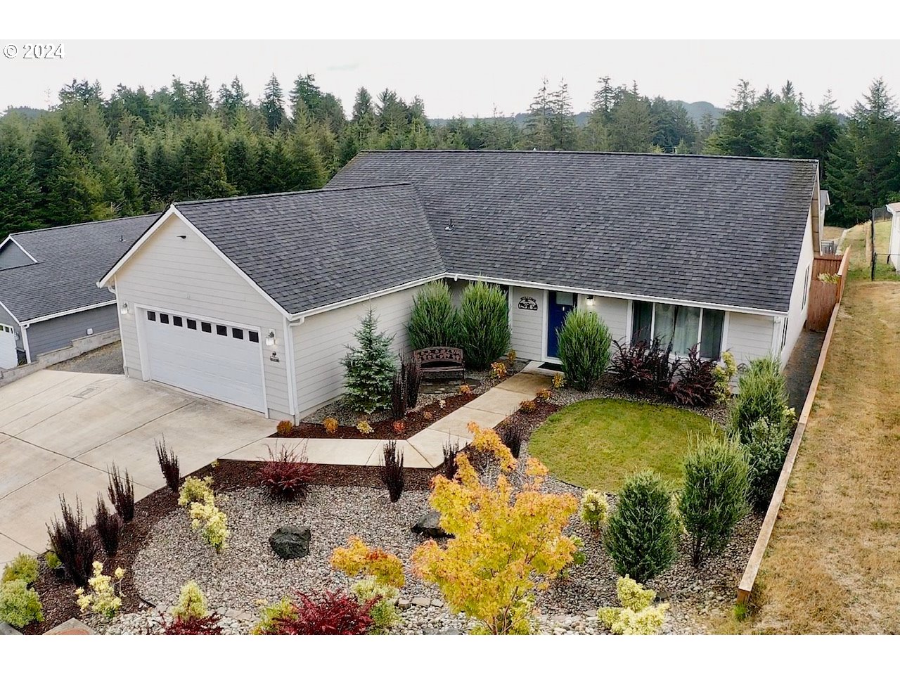 a view of a house with pool plants and large trees