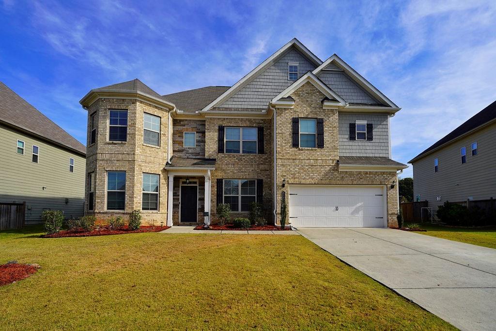 a front view of a house with a yard