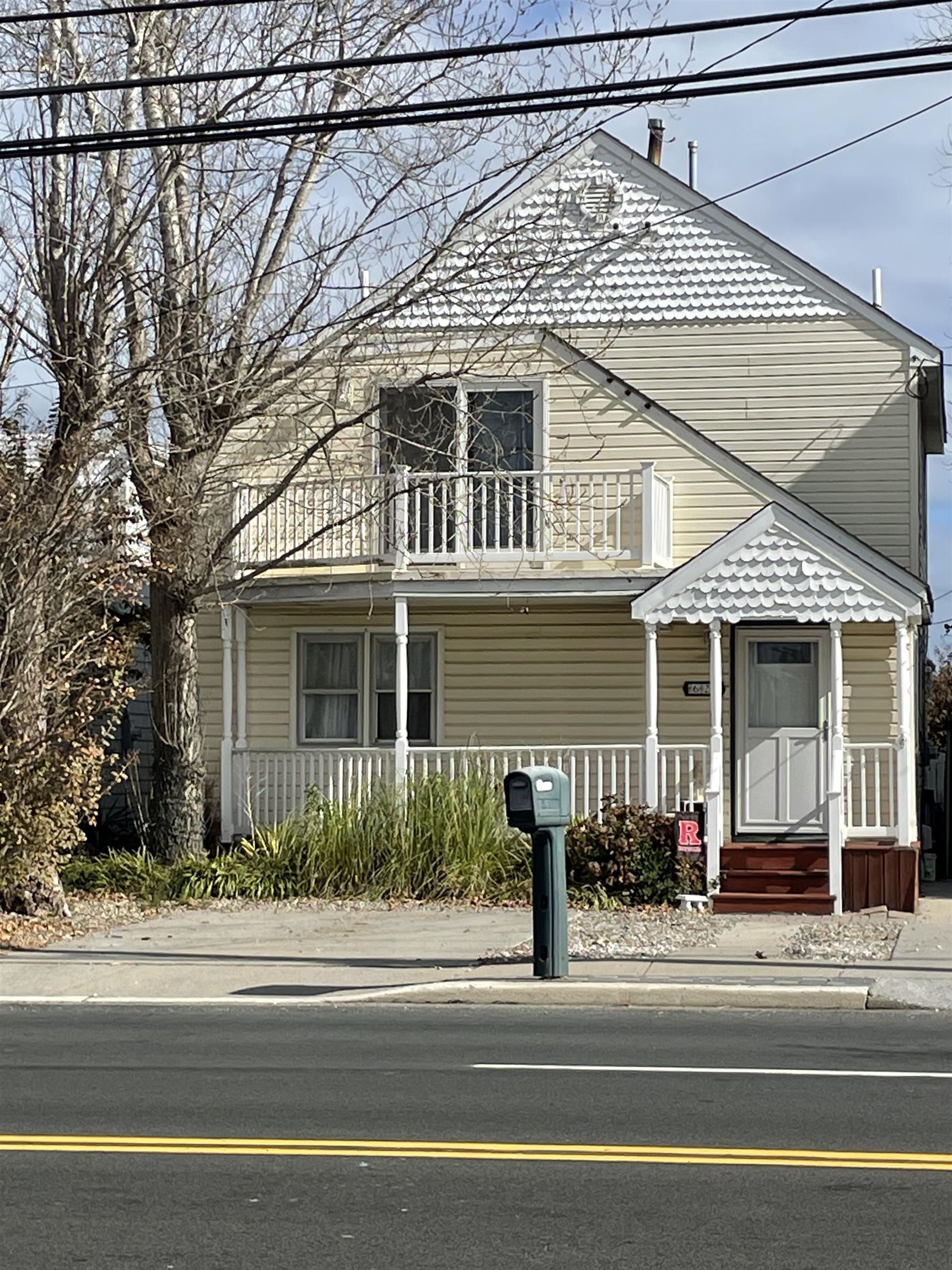 a front view of a house with a small yard