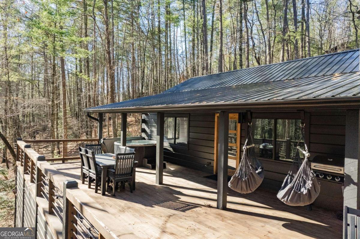 a view of deck with table and chairs with wooden floor and fence