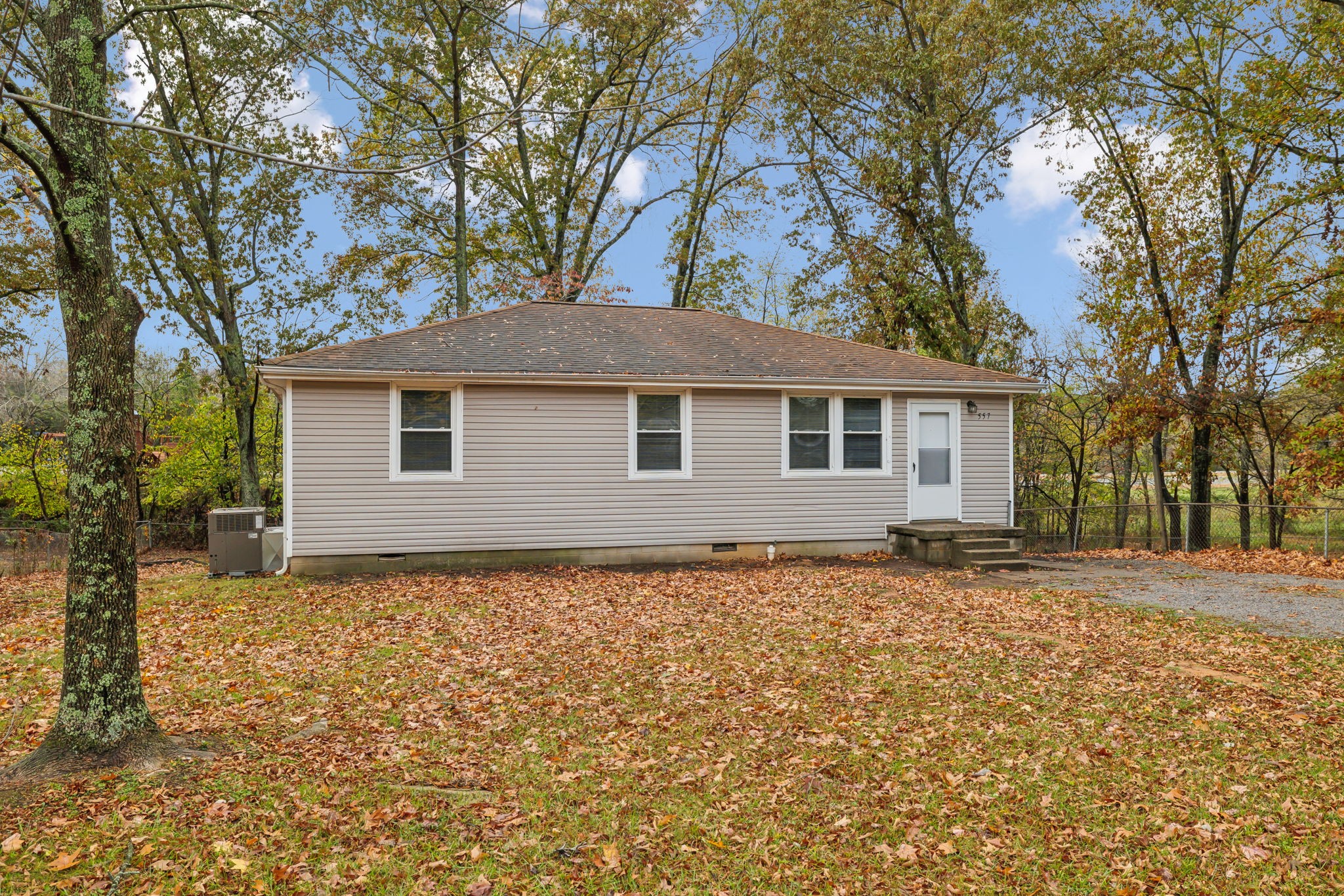 a backyard of a house with large trees