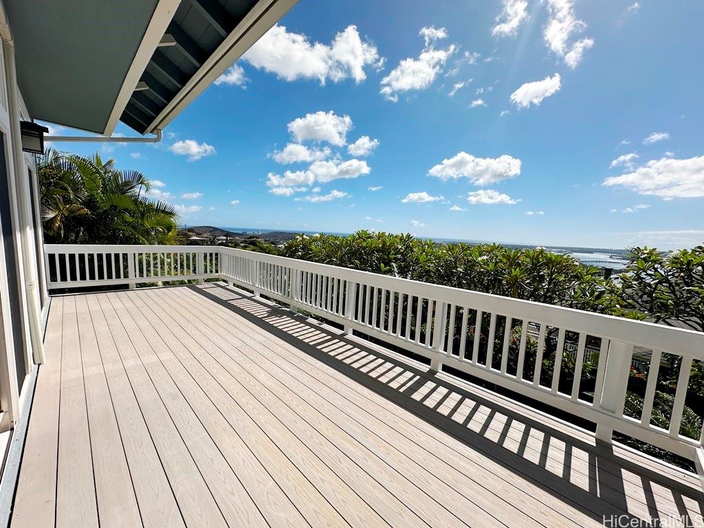 a view of a balcony with wooden floor