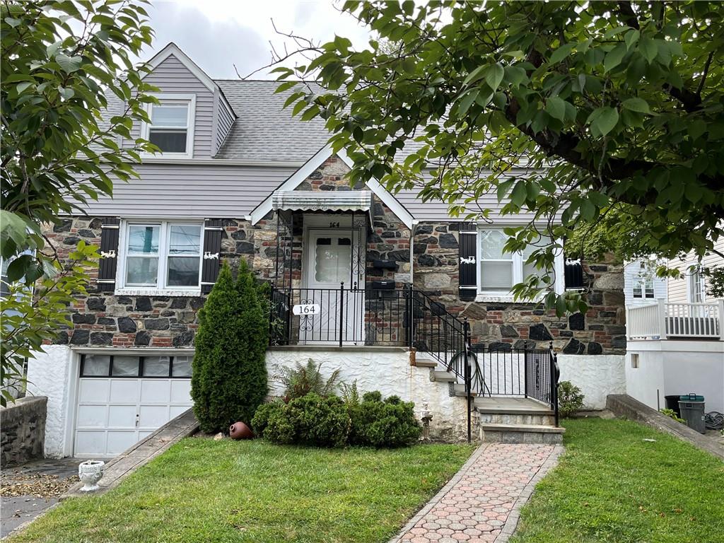 a front view of a house with a garden and plants