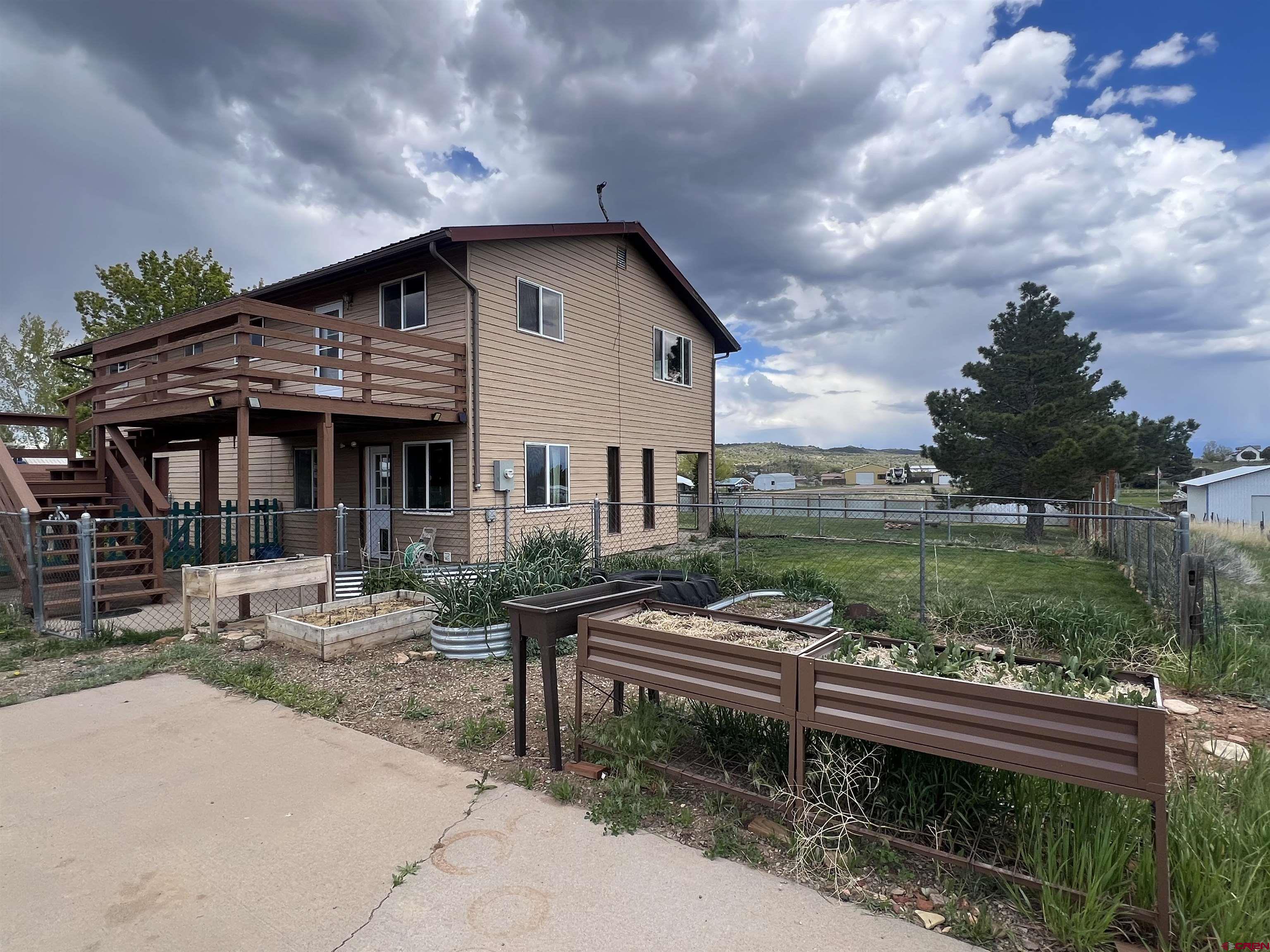 a view of a house with backyard and sitting area