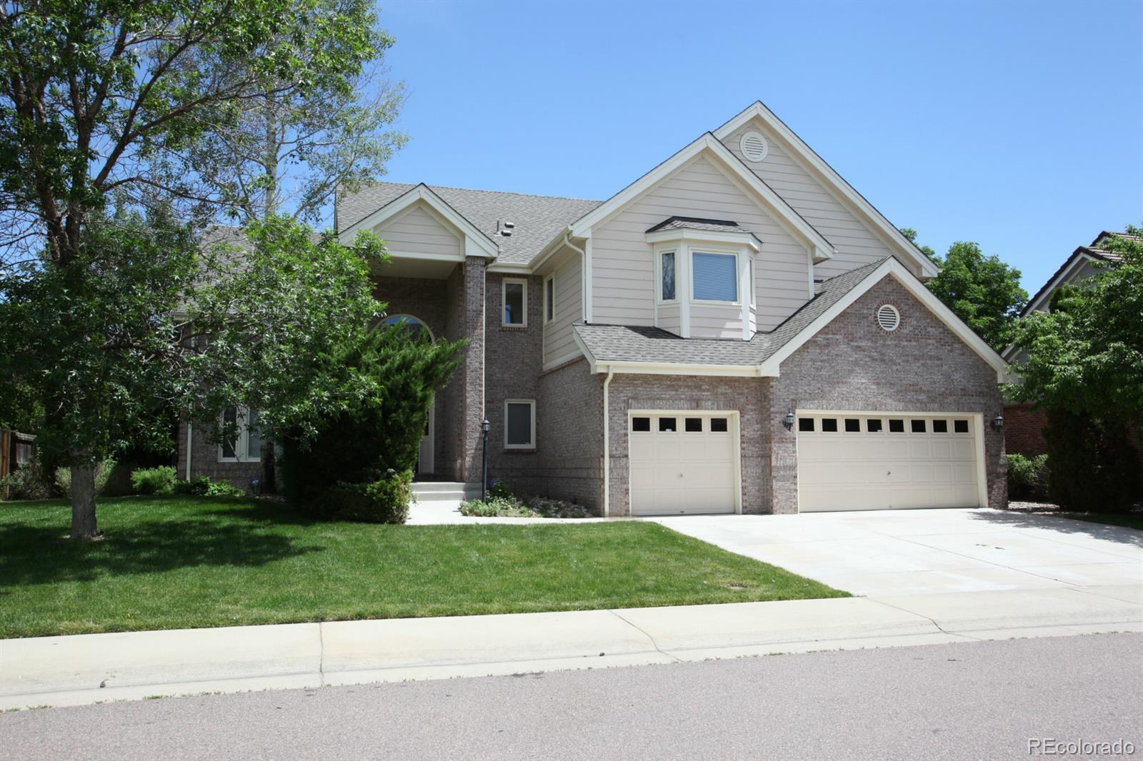 a view of house with yard and green space