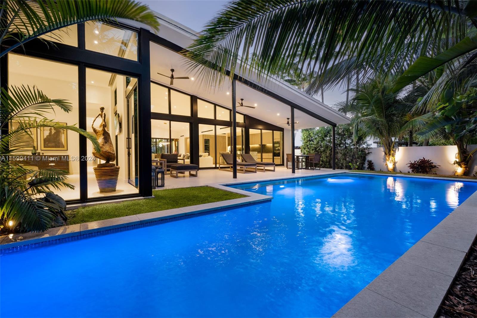 a view of swimming pool with a table and chairs under an umbrella