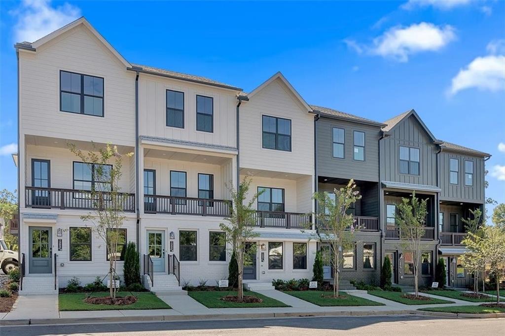 a front view of a residential apartment building with a yard