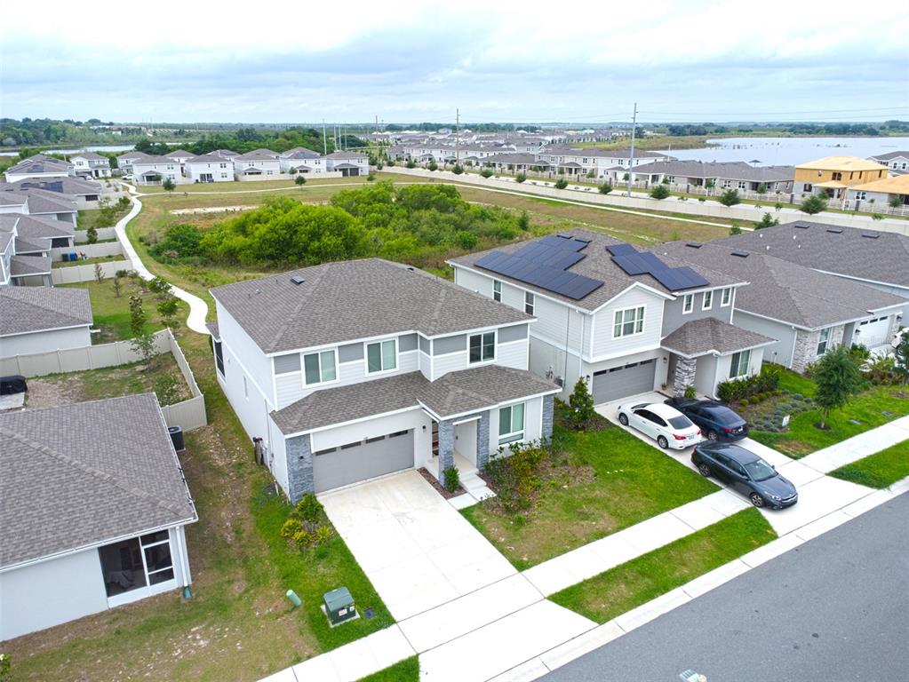 an aerial view of a house with a garden and lake view