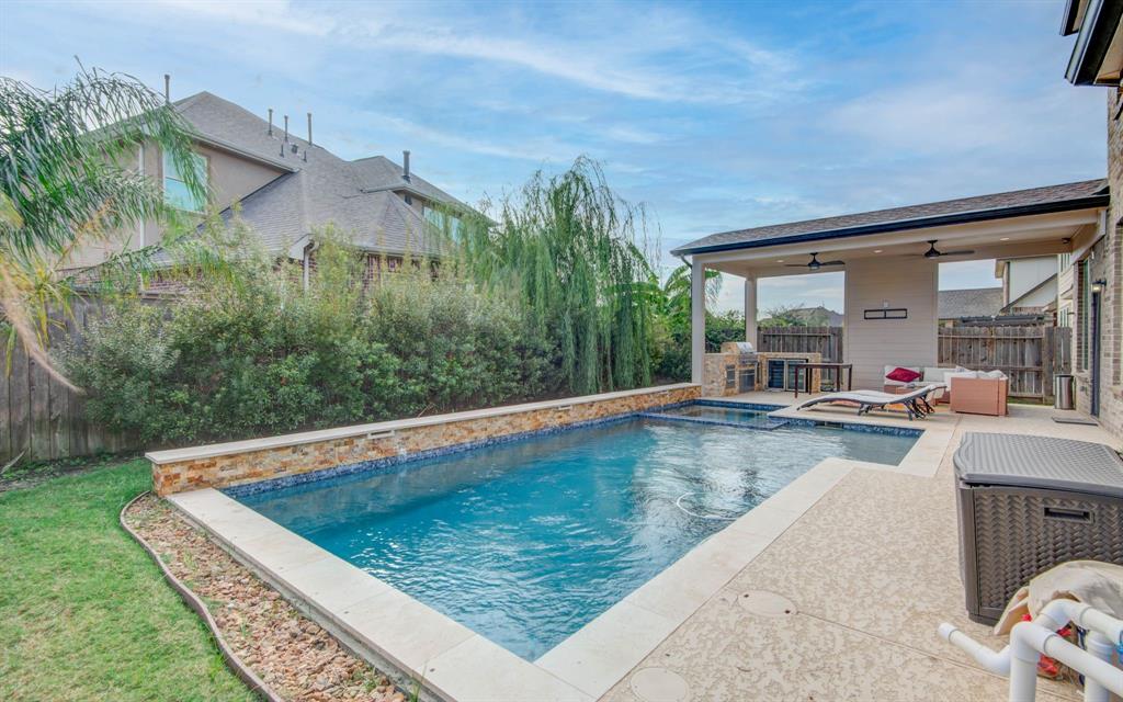 a view of a swimming pool with a patio