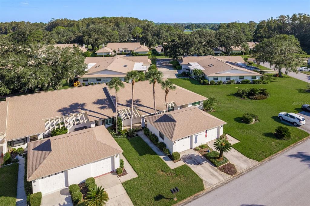 an aerial view of a house with garden space and street view