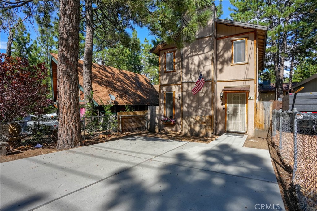 a view of a house with a tree in the background