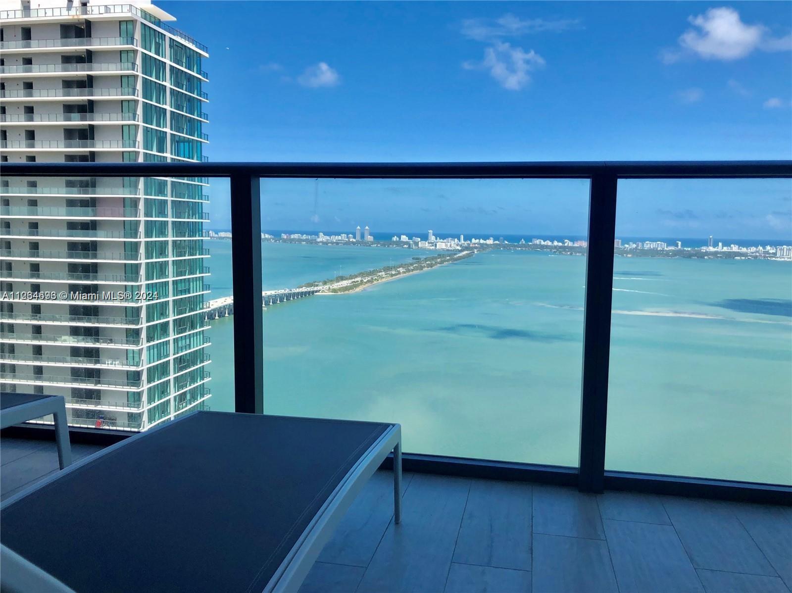 a view of balcony with floor to ceiling window and wooden floor