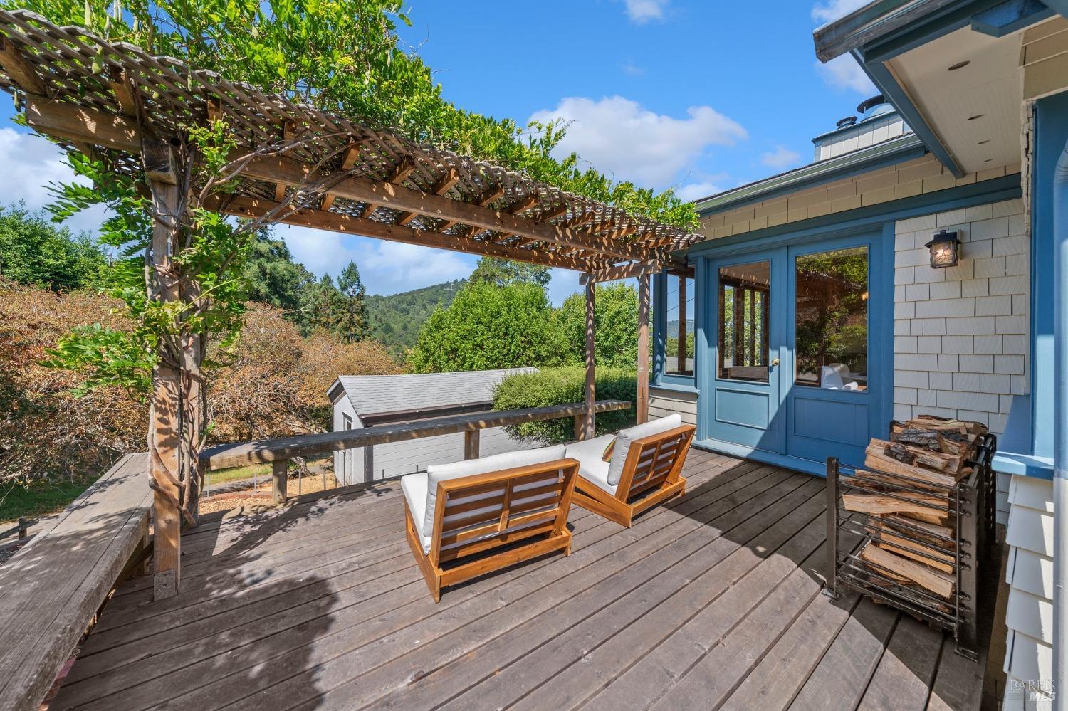 a view of a patio with table and chairs with wooden floor and fence