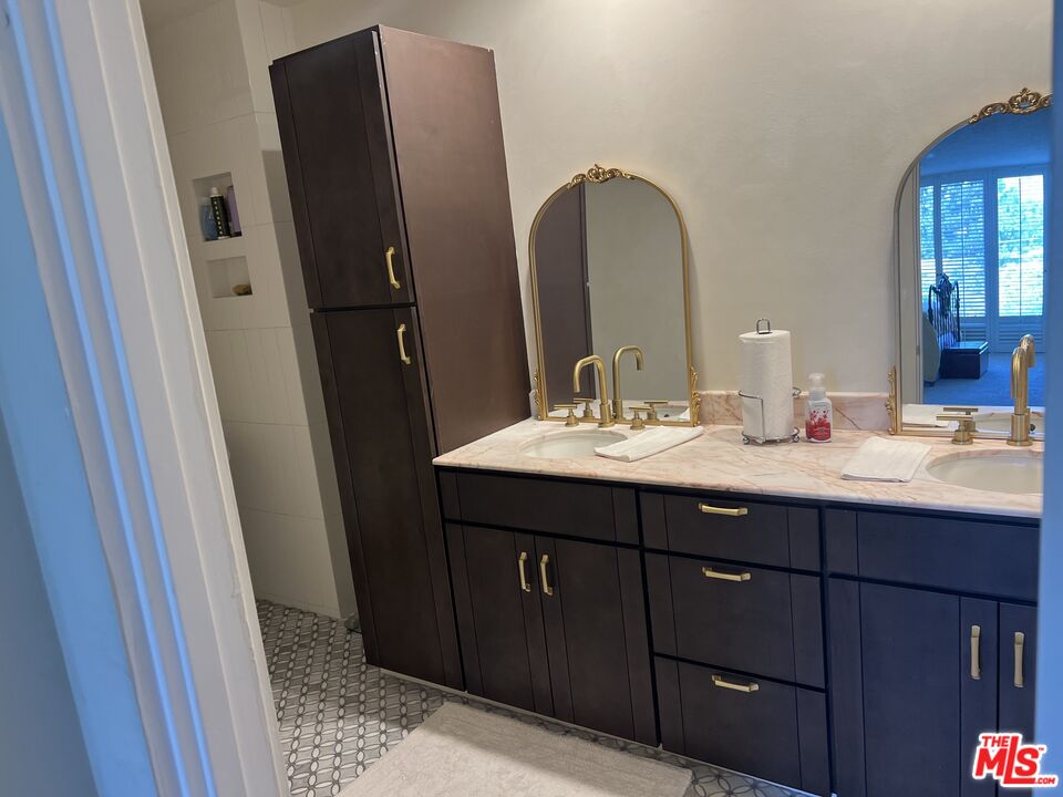 a bathroom with a double vanity sink and mirror