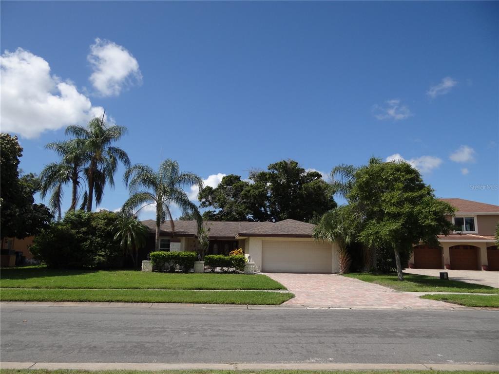 a front view of a house with a garden and a yard