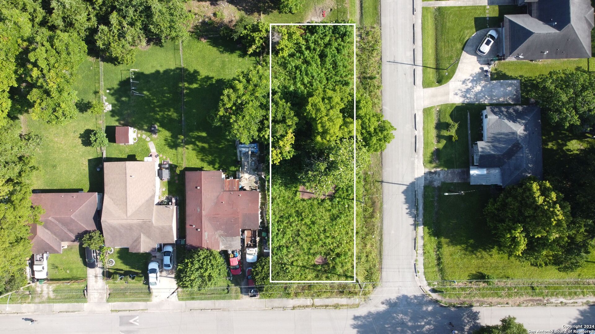 an aerial view of a house with garden space and street view