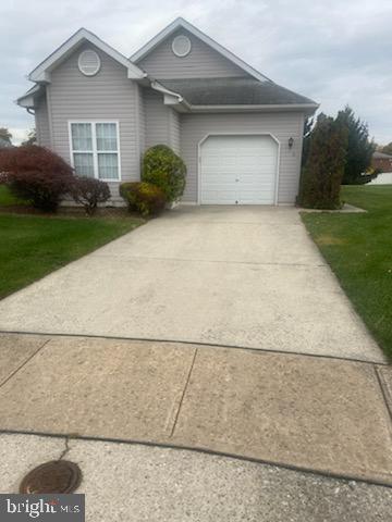 a view of a house with a yard and garage