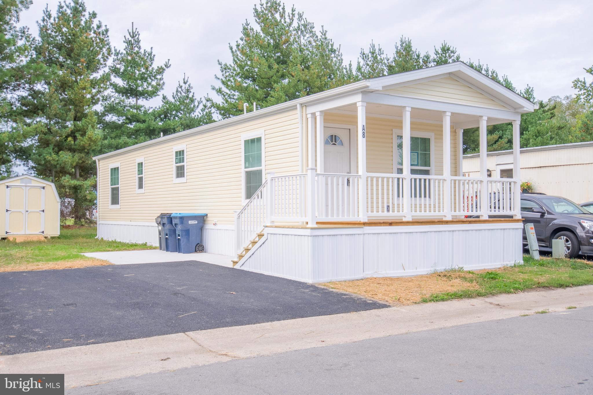 a front view of a house with a yard and a garage