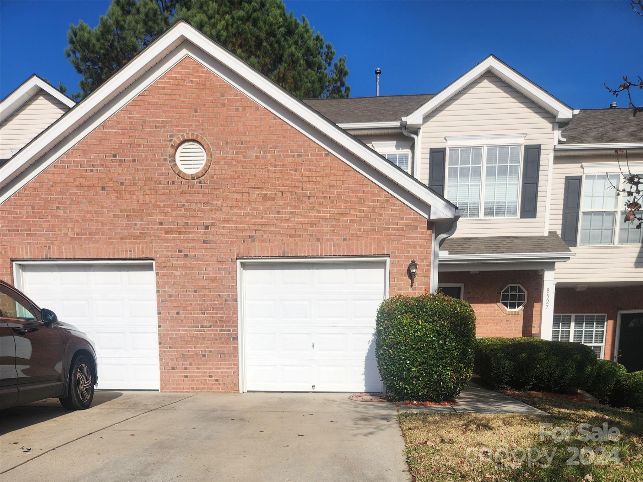 a view of a house with a yard and garage