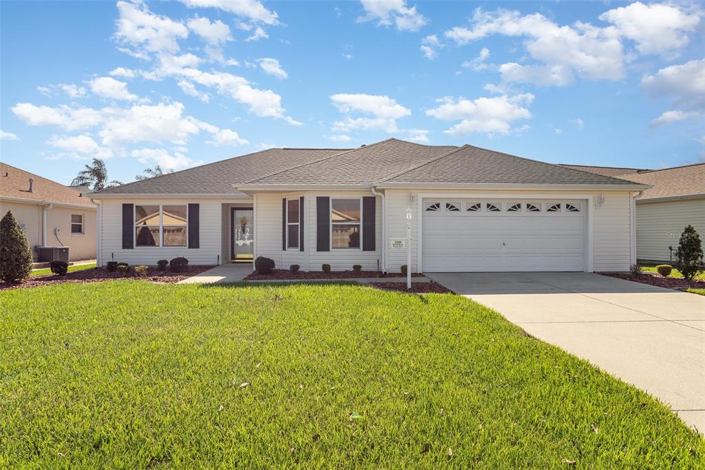 a front view of a house with yard patio and outdoor seating