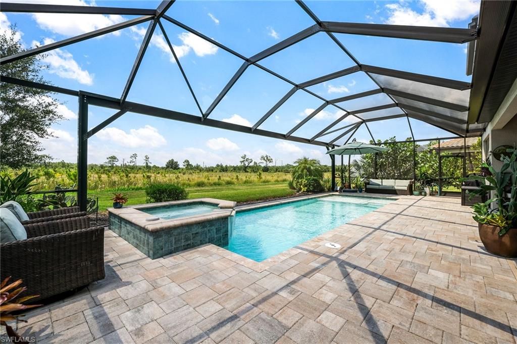 a view of a patio with a table and chairs under an umbrella