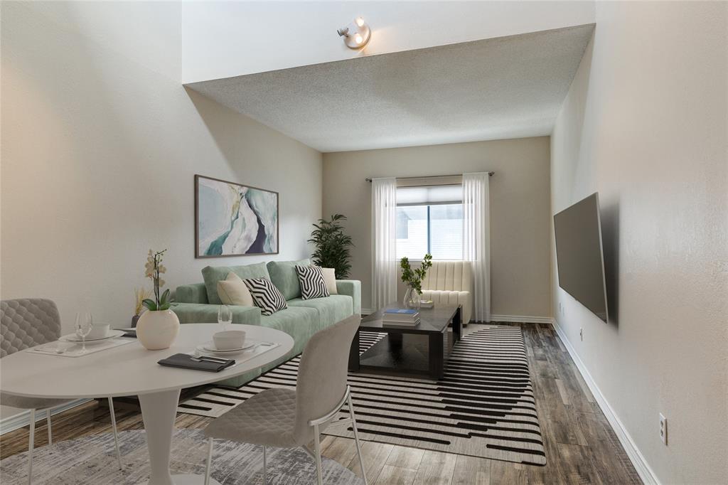 a living room with furniture a rug and a flat screen tv