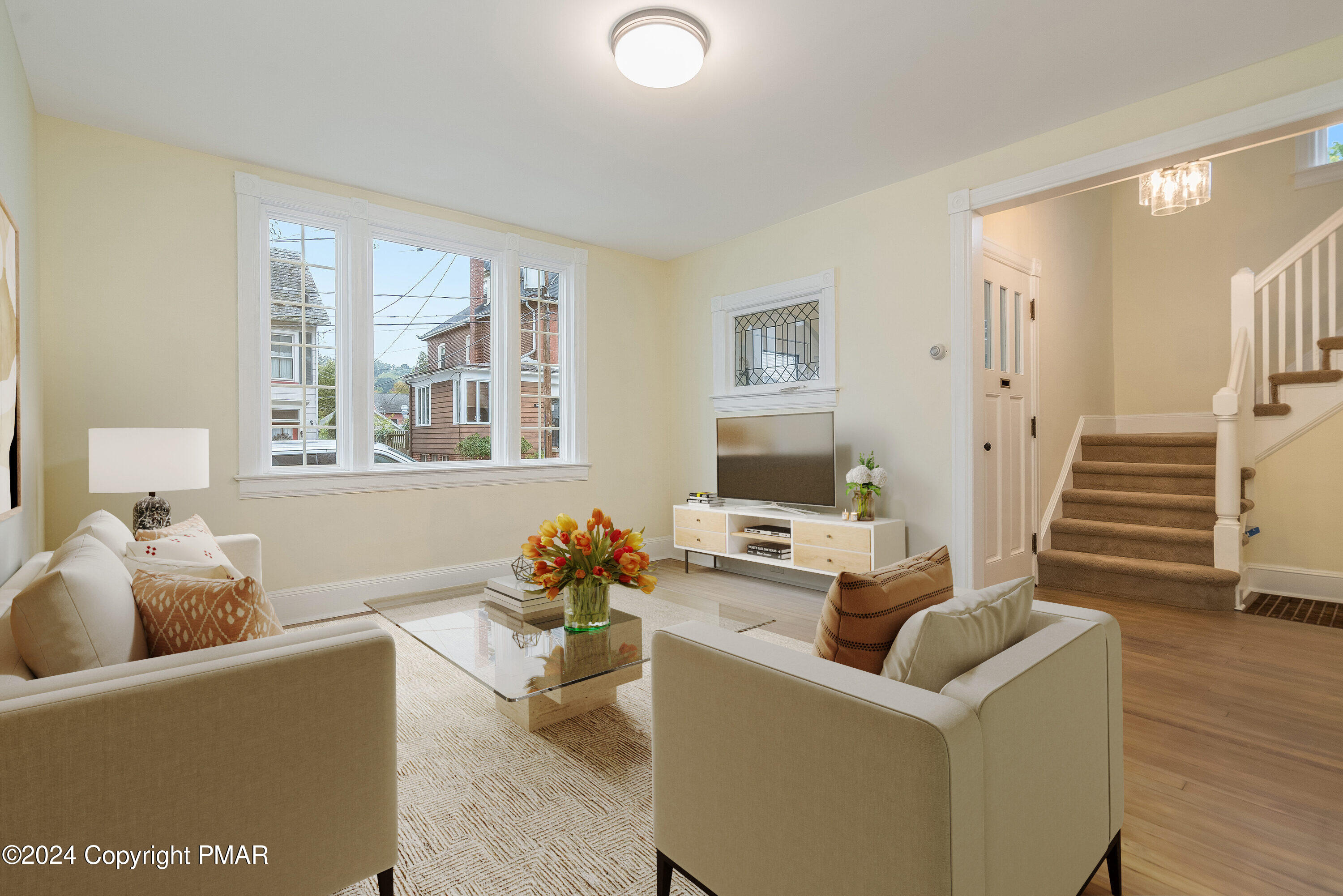 a living room with furniture and a flat screen tv