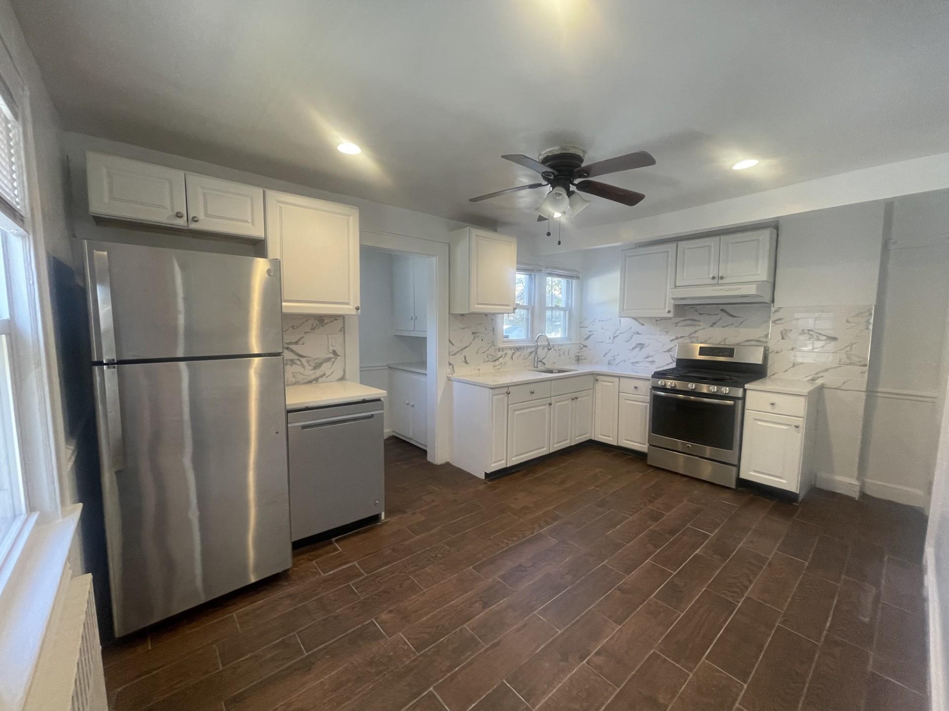 Newly upgraded sunny and large eat-in kitchen with recessed lighting and stainless steel appliances