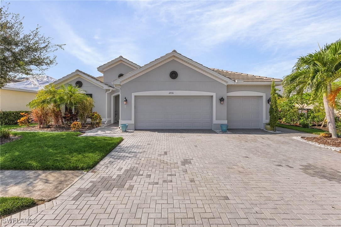 a front view of a house with a yard and garage