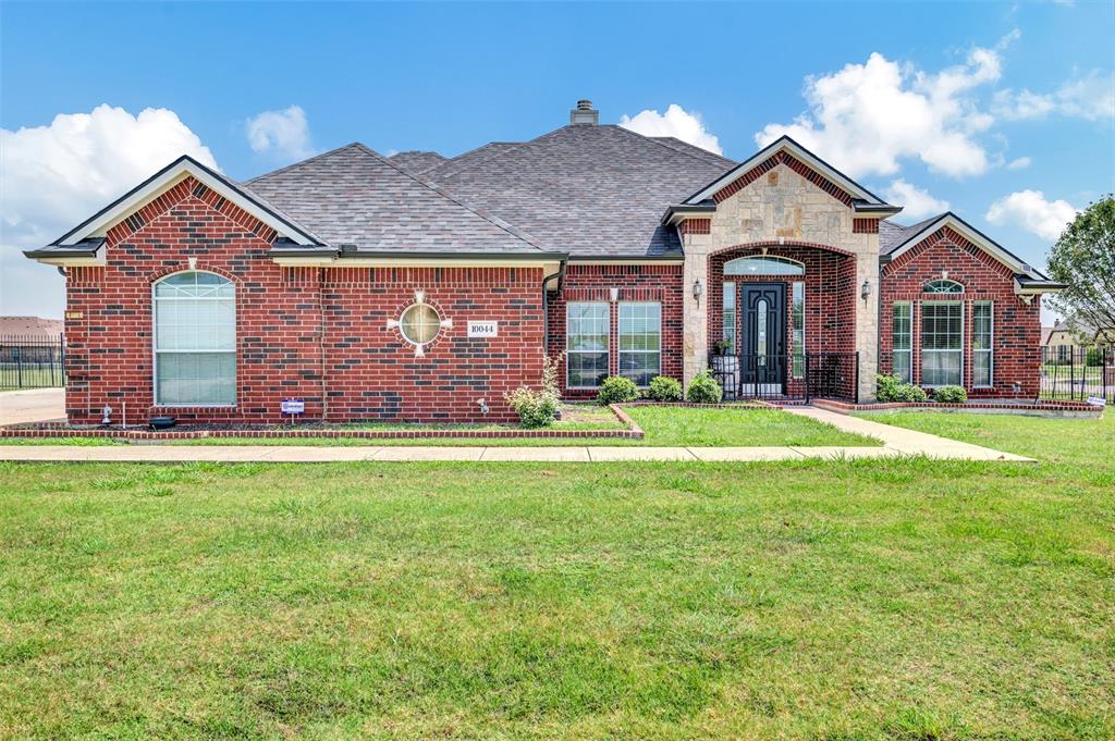 a front view of house with yard and outdoor seating