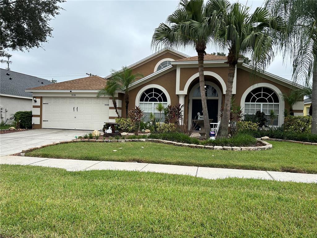 a front view of a house with a garden