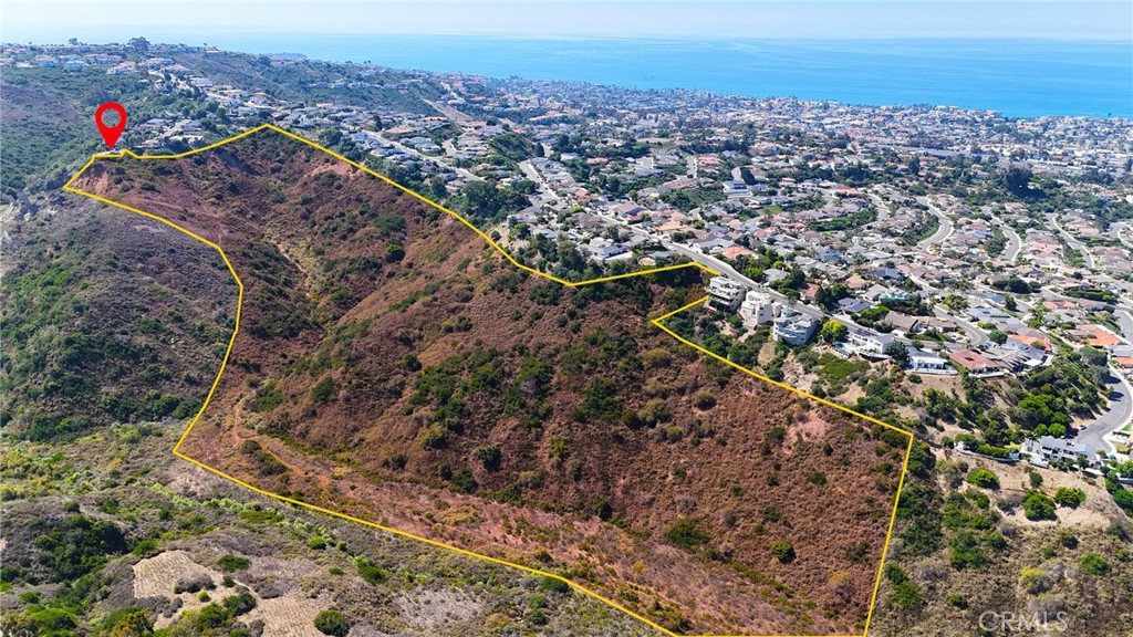 an aerial view of a houses with a yard