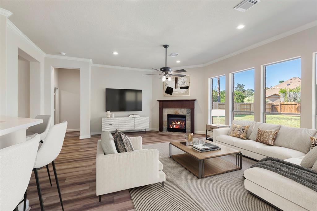 a living room with furniture a flat screen tv and a fireplace