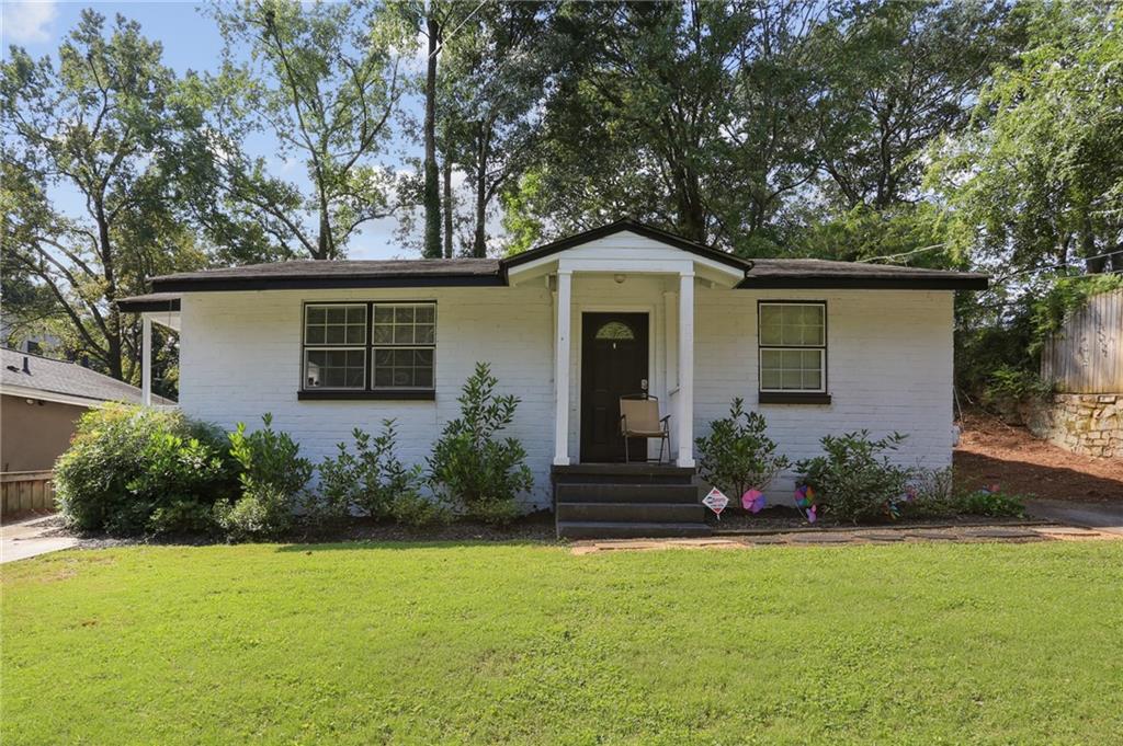 a front view of house with yard and green space