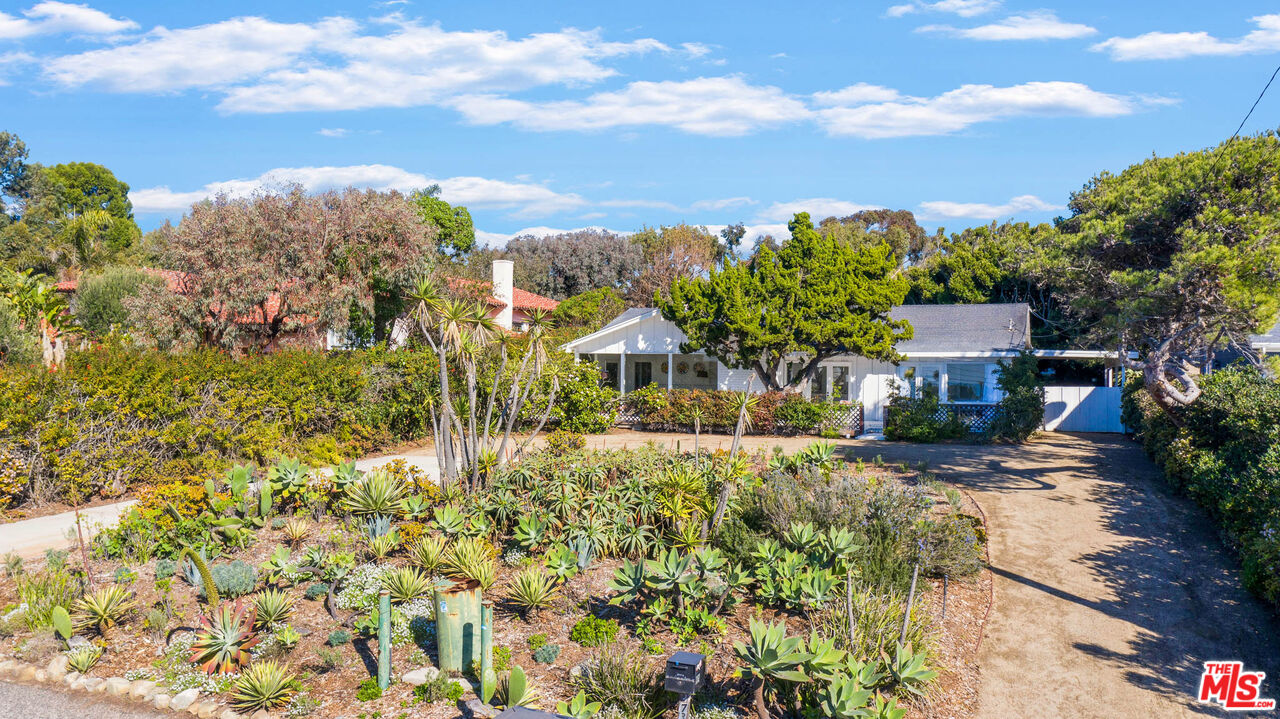 a view of a house with a yard and sitting area