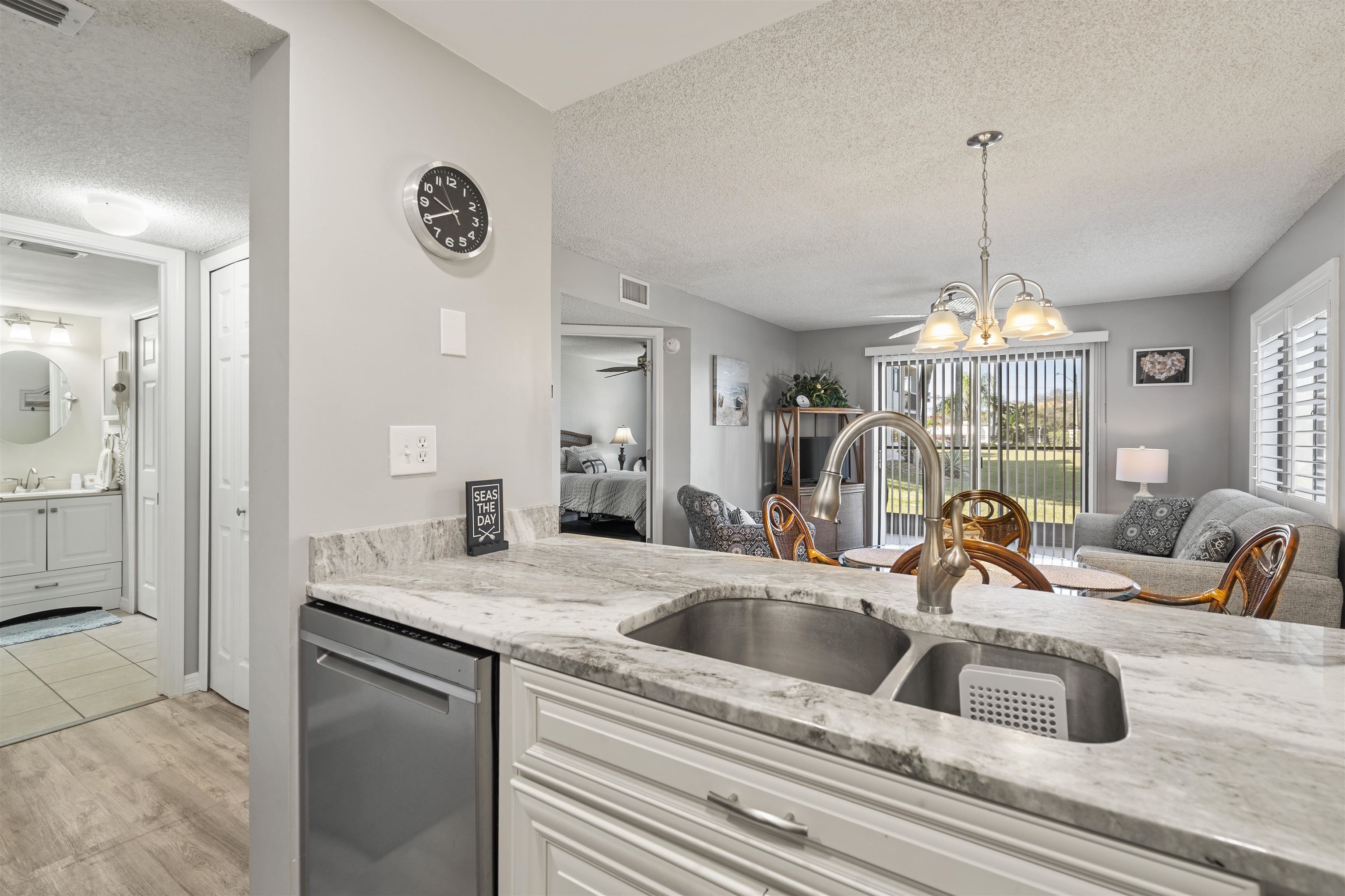 a kitchen with a sink and a chandelier