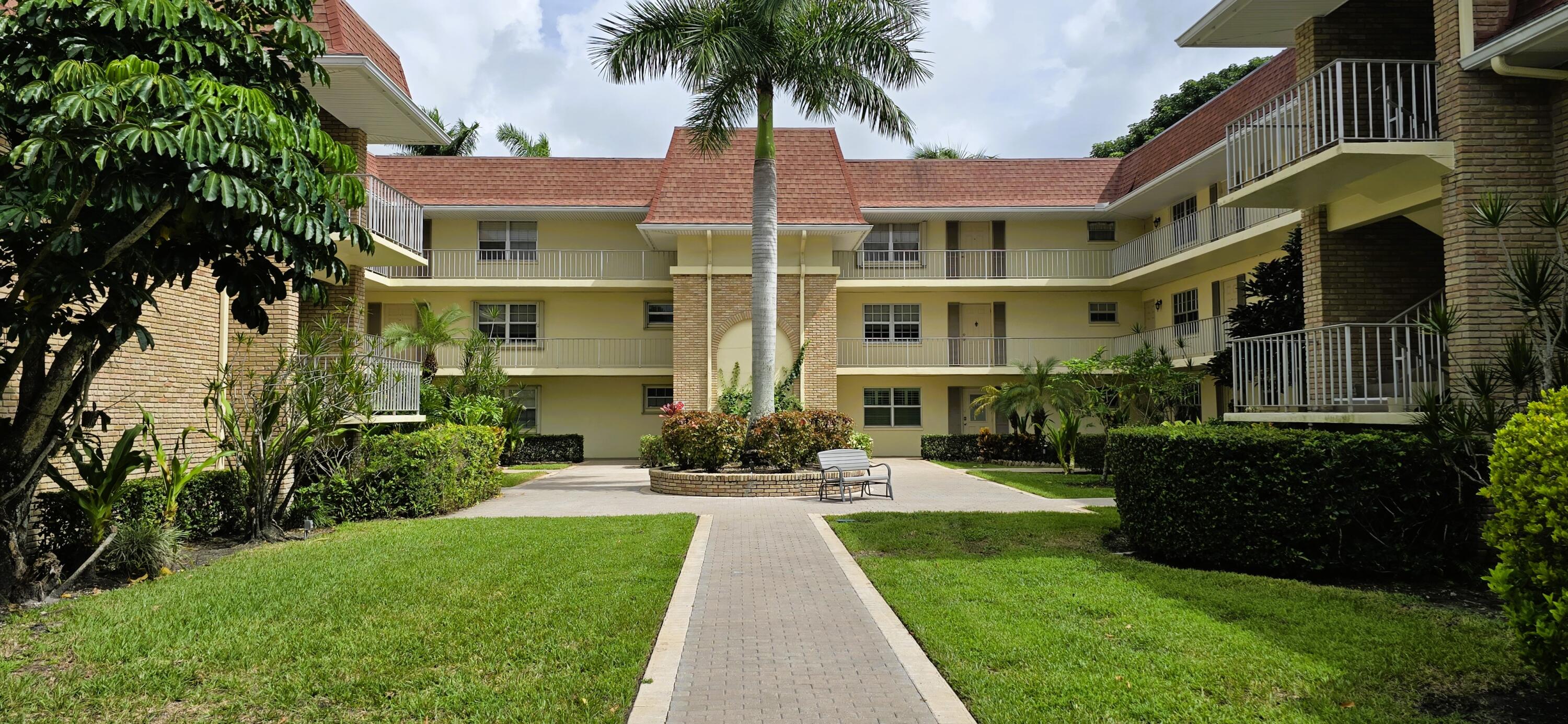 a front view of a residential apartment building with a yard