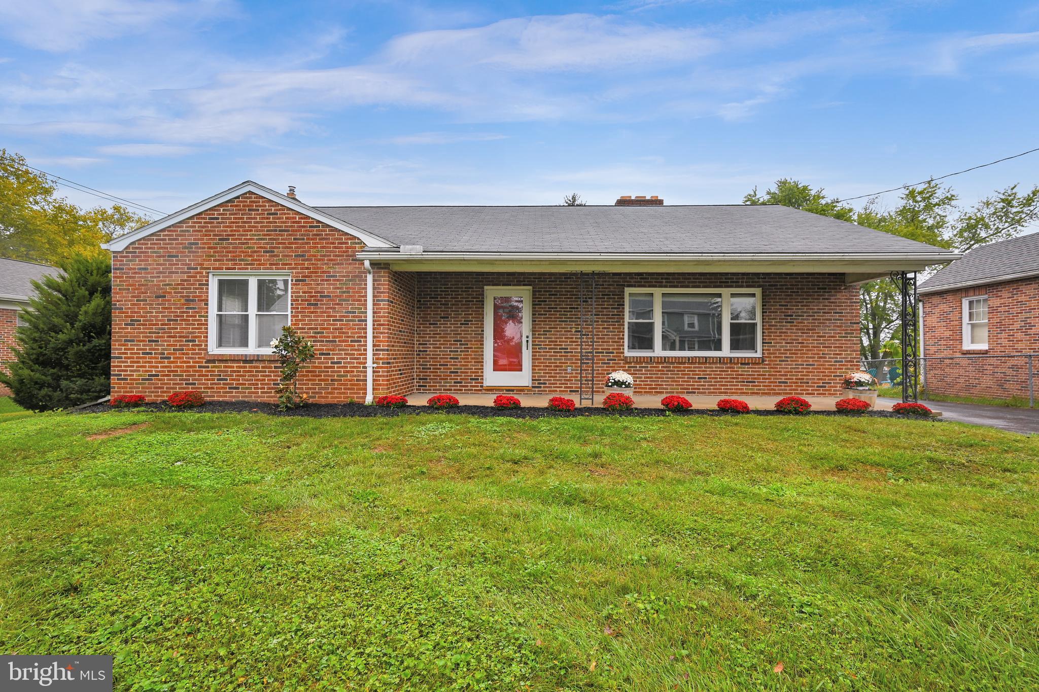 a front view of house with yard and green space