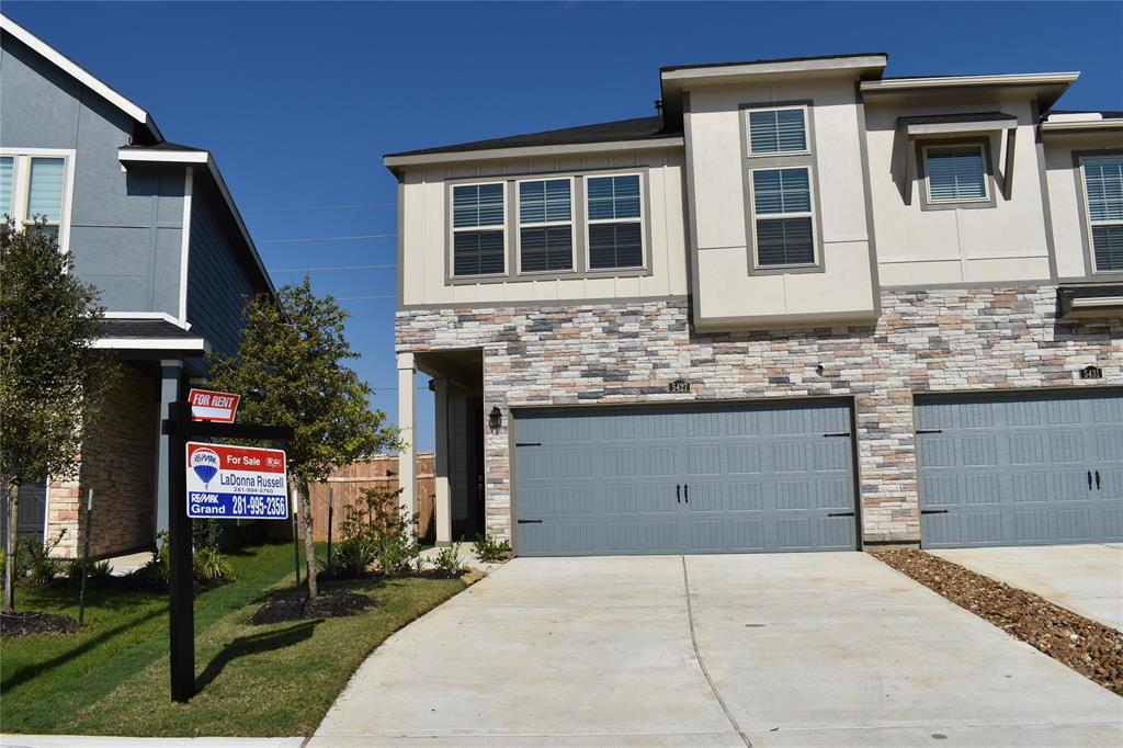 a front view of a house with a yard and garage