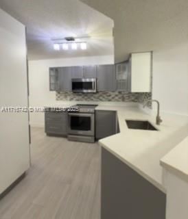 a kitchen with stainless steel appliances granite countertop a sink and a stove top oven