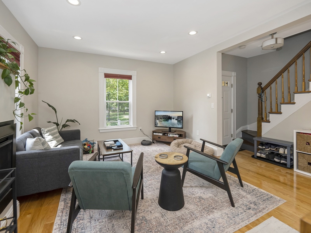 a living room with furniture a window and a flat screen tv