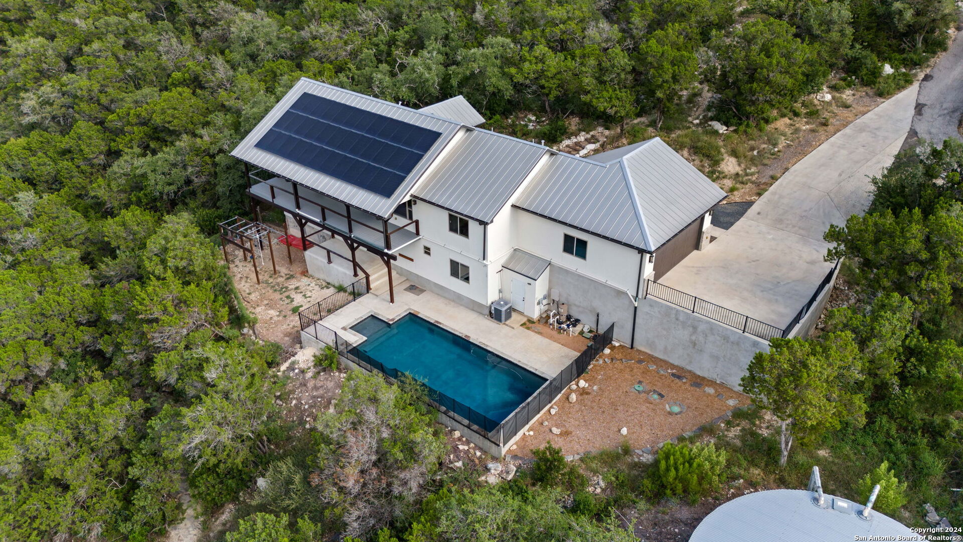 an aerial view of a house with a yard