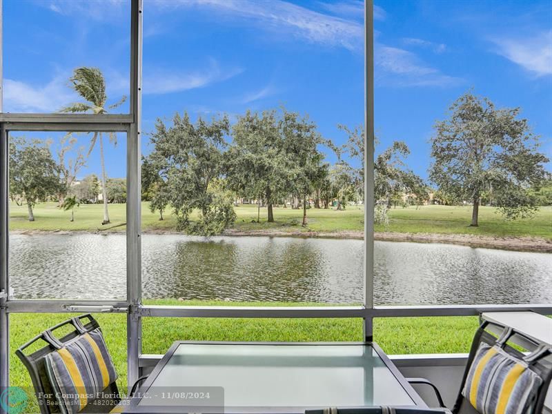 a view of outdoor space with seating area and city view