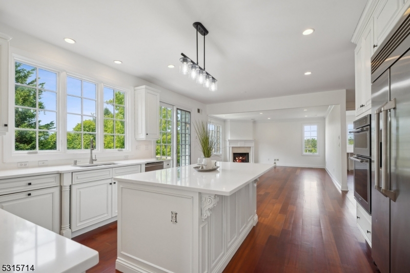 a kitchen with counter top space a sink appliances and cabinets