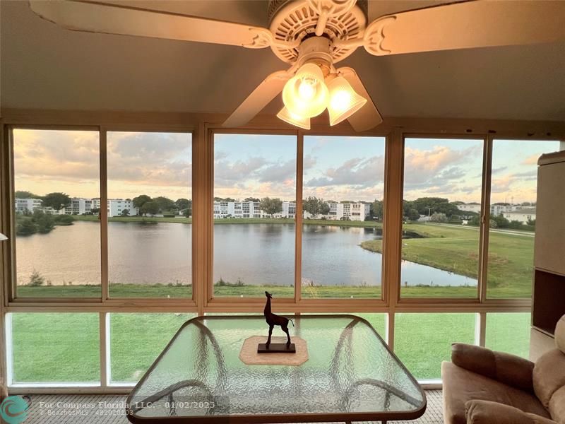 a room with pool table and windows