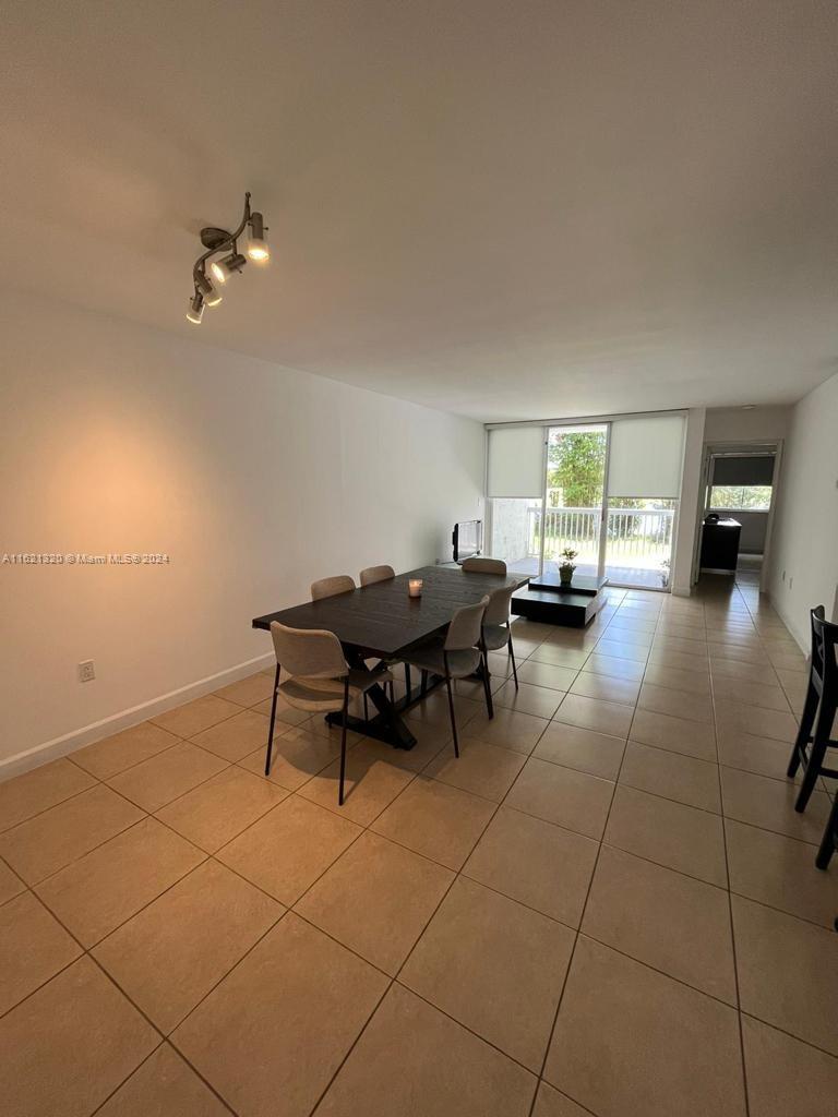 a dining room with a rug a ceiling fan and a rug